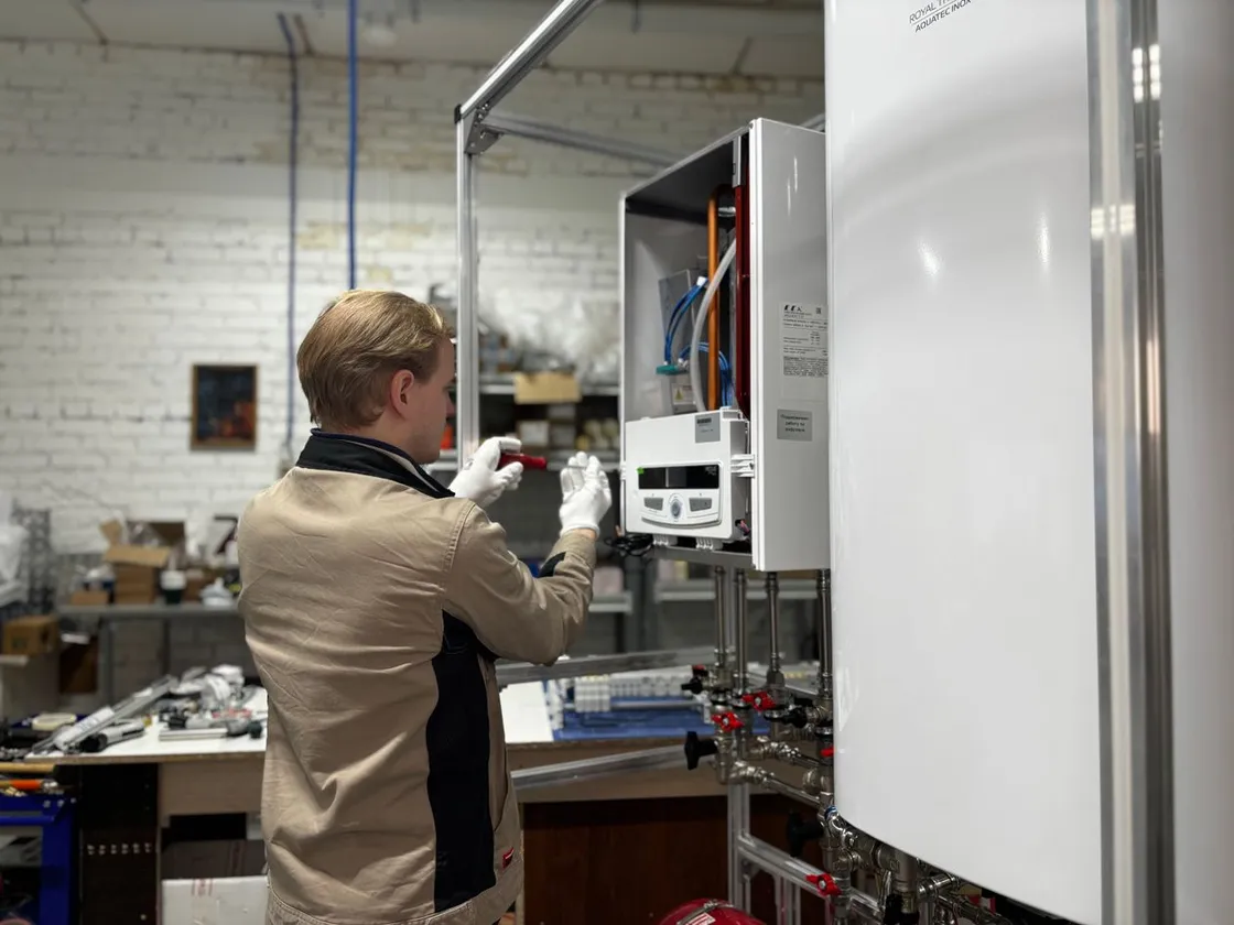 Plumber inspecting a residential water heater in Fort Worth
